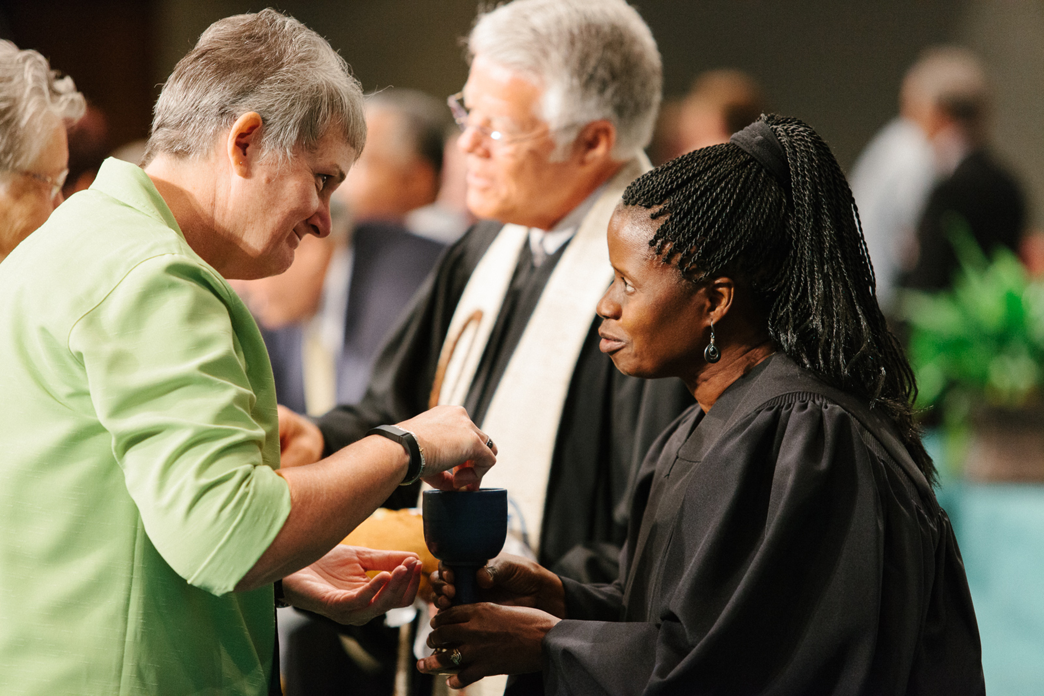 The Rev. Tonya Elmore, pastor at Enterprise First United Methodist Church, takes communion from the Rev. Virginia Kagoro, pastor at Locust Bluff United Methodist Church during the 2015 Alabama-West Florida Conference. Photo by Luke Lucas, Alabama-West Florida Conference.