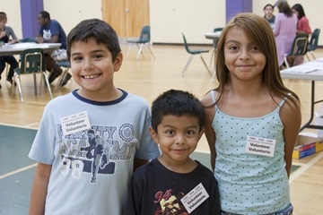 Children volunteer and welcome clients at the JFON legal immigration clinic