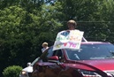 Sharon Lowe Hennis of Sedge Garden United Methodist Church displays a sign in appreciation of the church's pastor during a parade. Photo courtesy of Sedge Garden United Methodist Church.